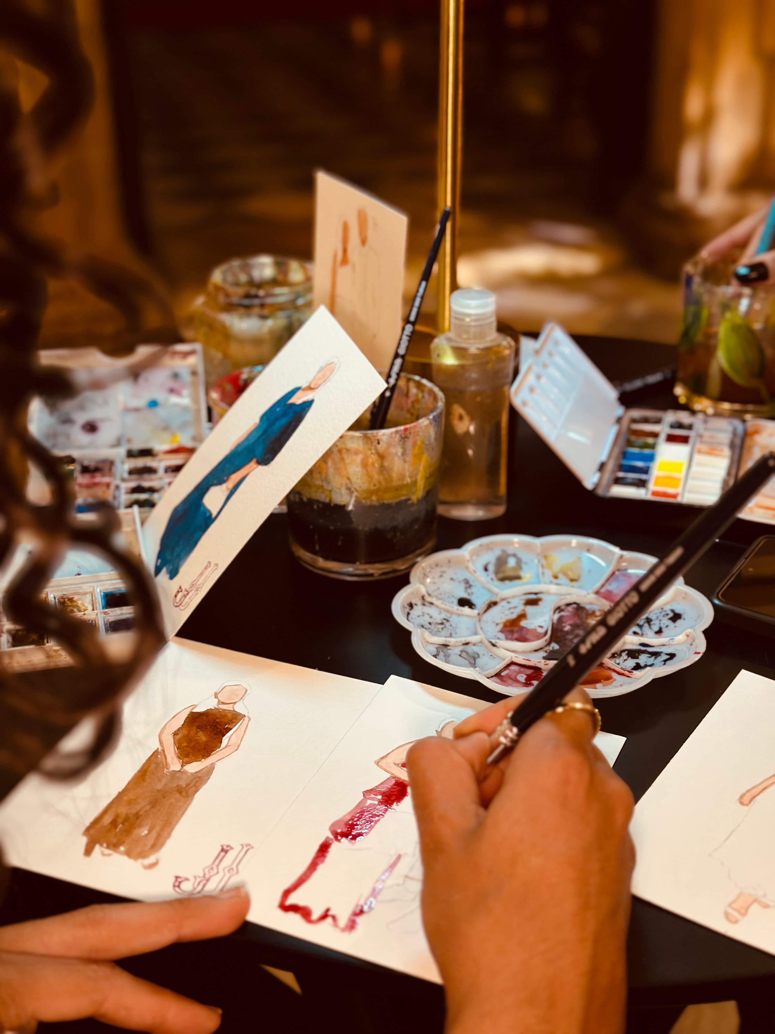 Artist painting a wedding scene outdoors